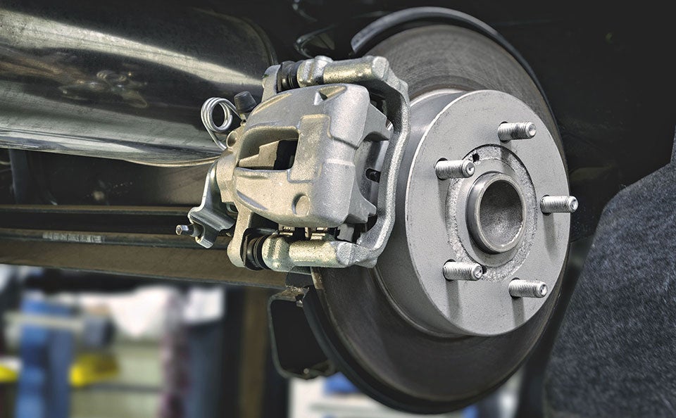 An image of OEM brakes being installed on a vehicle. 